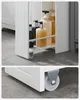 A close-up view of a white slim cabinet with wheels, showing bottles of toiletries inside. Náhled obrázku produktu
