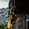 A string of warm white LED lights hangs from the eaves of a building. Podgląd zdjęcia produktu
