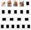 A collection of photo frames, some with pictures inside and some empty. Produktbild-Vorschau