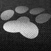 A close-up view of a dog paw print pattern on a dark gray textured surface. Náhled obrázku produktu