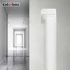 A white ventilation duct fitting is mounted on a textured wall, with a blurred hallway in the background. Podgląd zdjęcia produktu