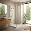 A modern bathroom with a walk-in shower, vanity, and a large window overlooking a garden. Produktbild-Vorschau