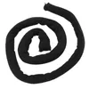 A black coiled fabric tube, likely a hair accessory, is presented against a white background. Náhled obrázku produktu