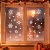 Christmas-themed window decorations with snowflakes applied to a window, with a street lamp visible outside. Produktbild-Vorschau