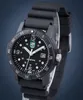 A close-up studio shot of a black Luminox watch with a black rubber strap against a blue background. Produktbild-Vorschau