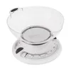 A white mechanical kitchen scale with a transparent bowl. Voir les images du produit