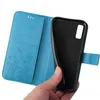 A hand holding a blue flip phone case open, revealing the black interior where a phone would be placed. Produktbild-Vorschau