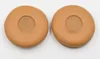 Two brown ear pads for headphones are shown on a white background. Produktbild-Vorschau