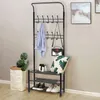 A black metal coat rack with shoe shelves is shown against a light gray wall. Náhled obrázku produktu