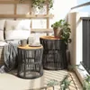 Two round side tables with wooden tops and woven bases are placed on a balcony next to a sofa. Náhled obrázku produktu