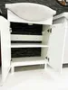 A white bathroom cabinet with its doors open, revealing shelves and a black textured back panel. A white sink is mounted on top. Produktbild-Vorschau