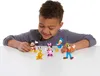 A young boy is playing with a set of Disney character figurines on a white table. Náhľad obrázku produktu