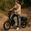 A young man is riding an electric scooter on a dirt path in a natural setting. Produktbild-Vorschau
