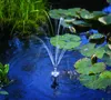 A solar-powered fountain is operating in a pond with lily pads and grass. Anteprima dell’immagine prodotto