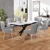 A dining room scene with a table and chairs.