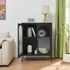 A black sideboard with glass doors is shown in a living room setting next to a sofa and a plant. Podgląd zdjęcia produktu