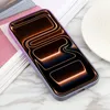 A smartphone case with a gradient color design is placed on a marble surface next to some papers and a white plate. Produktbild-Vorschau
