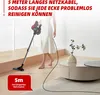 A person is using a cordless vacuum cleaner in a modern living room. Produktbild-Vorschau