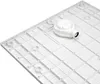 The underside of a white shower tray with a drain fitting attached. Produktbild-Vorschau