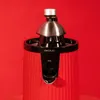 A close-up studio shot of a red electric juicer against a red background. Podgląd zdjęcia produktu