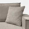 A close-up view of a gray corduroy sofa with pillows. Produktbild-Vorschau