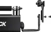 A close-up view of a black rotary roller accessory for a laser engraver, shown with its mounting hardware. Náhled obrázku produktu