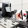 A kitchen scene with cabinets and a stove, featuring a close-up of a hand holding a black cabinet handle. Produktbild-Vorschau