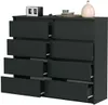 A dark gray dresser with eight drawers, some of which are open, is shown against a white background. Decorative items, including a clock, a small bowl with a patterned object, and a light pink vase, are placed on top of the dresser. Anteprima dell’immagine prodotto