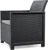A close-up side view of a black rattan-style garden chair with a gray cushion. Produktbild-Vorschau