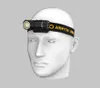 A white mannequin head wearing a black and yellow headlamp with the brand name 'ARMYTEK' visible. Produktbild-Vorschau