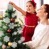 A mother and daughter decorating a Christmas tree. Produktbild-Vorschau