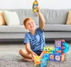 A young boy is playing with magnetic building blocks on the floor in a living room. Náhľad obrázku produktu