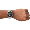 A man's wrist wearing a silver Emporio Armani watch with a black dial. Náhled obrázku produktu