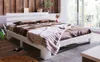 A bedroom scene with a white bed and brown bedding. Náhled obrázku produktu