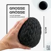 A hand holding a black, dragon egg-shaped object, with text overlays indicating size and comparison. Produktbild-Vorschau