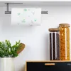 A kitchen counter with a paper towel holder mounted above it, and jars of food items. Produktbild-Vorschau