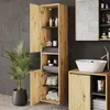 A modern bathroom with a tall wooden cabinet filled with toiletries and towels, a sink, and a plant. Podgląd zdjęcia produktu