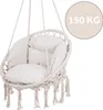 A beige macrame hanging chair with cushions, shown against a white background. A circular overlay indicates a weight limit of 150 KG. Náhled obrázku produktu