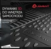 A close-up view of black 3D car floor mats with a textured surface and the brand logo embossed on them. Text overlays in Polish describe the product. Podgląd zdjęcia produktu