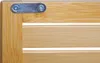 A close-up view of a corner of a wooden shelf unit, showing a metal bracket with screws. Produktbild-Vorschau