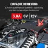 A car battery charger is shown connected to a car battery in an engine bay. Produktbild-Vorschau