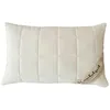 A white quilted pillow on a white background. Produktbild-Vorschau