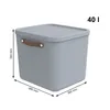 A gray storage box with a lid and brown handles, shown with dimensions and capacity indicated. Produktbild-Vorschau
