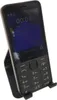 A black Nokia feature phone is displayed on a black stand against a white background. Podgląd zdjęcia produktu
