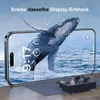A smartphone displaying a whale breaching from the ocean, with a couple sitting on a sofa in the foreground. Produktbild-Vorschau