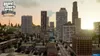 A cityscape at sunset, with buildings and a highway. Produktbild-Vorschau