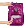 Hands are shown attaching decorative charms to a purple backpack with a star and unicorn theme. Voir les images du produit