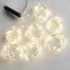 A bundle of LED string lights coiled on a textured surface. Produktbild-Vorschau