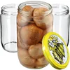 Three glass jars, one filled with preserved food and a yellow lid with a floral design, are arranged on a white background. Produktbild-Vorschau