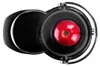 A top-down view of a black juicer with a red apple inside. Náhled obrázku produktu